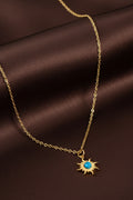 Collana dorata con sole e pietra turchese